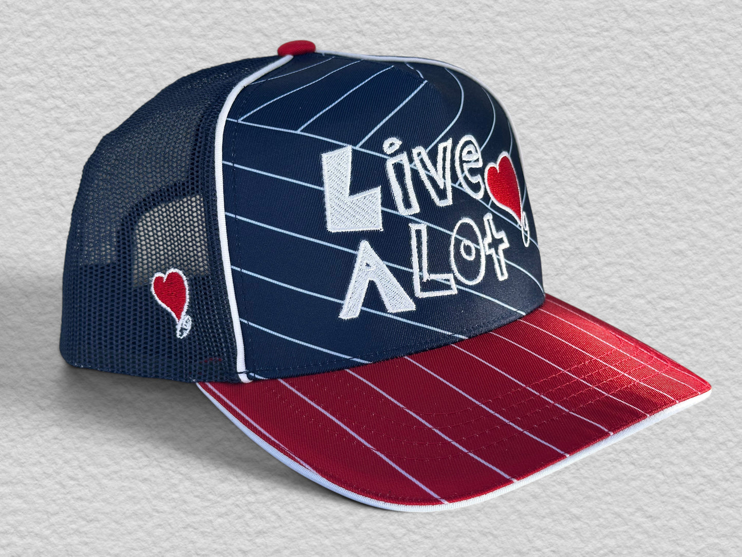 LIVE A LOT — Red, White & Blue Pinstripe Trucker Hat...