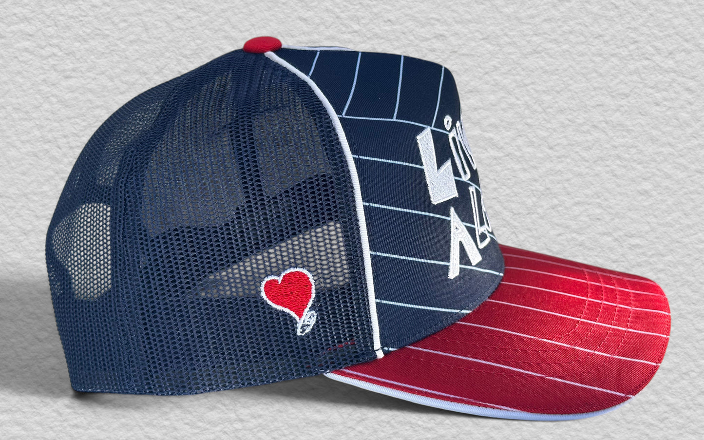 LIVE A LOT — Red, White & Blue Pinstripe Trucker Hat...